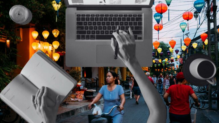 Hands lay on a laptop and book as someone learns online business tips against a backdrop of a busy Vietnamese street.